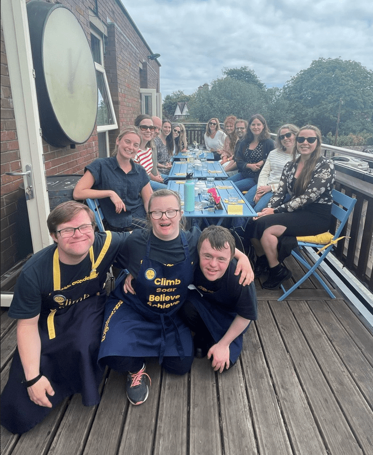 the SEI team featuring 3 students of the together academy wearing aprons reading 'climb, soar, schieve'